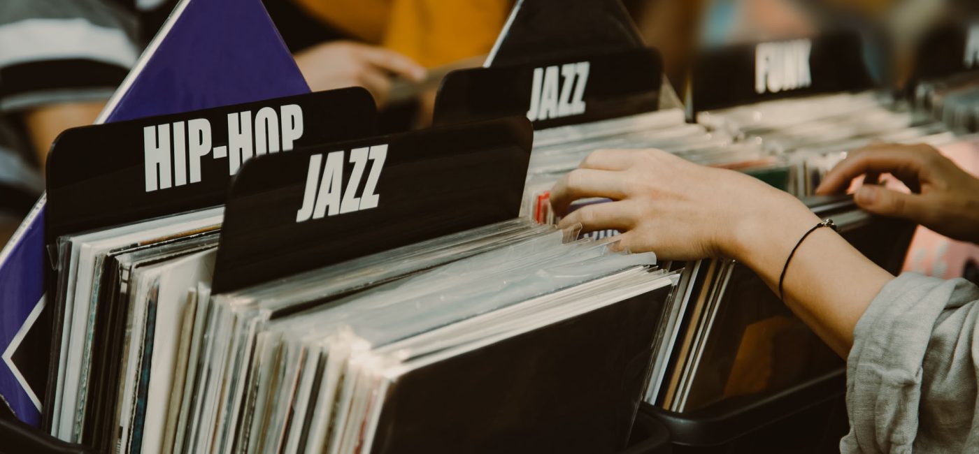 Woman is choosing a vinyl record in a musical store